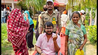 A voter on a wheelchair shows his ink-marked finger after casting his vote for the last phase of Lok Sabha Polls at a polling station in Uttar Pradesh on Saturday. (CEO UP-x) A voter on a wheelchair shows his ink-marked finger after casting his vote for the last phase of Lok Sabha Polls at a polling station in Uttar Pradesh on Saturday. (CEO UP-x)
