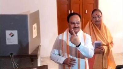 BJP president JP Nadda with wife Mallika after casting their votes at a polling booth in Bilaspur, Himachal Pradesh, on Saturday. (HT photo)