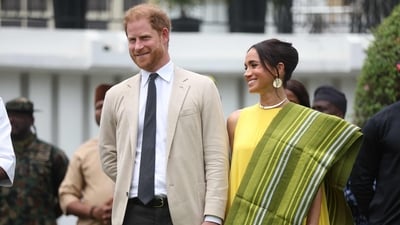 Prince Harry and Meghan Markle blasted for ‘taking advantage’ while royals are unable to conduct overseas tours (Photo by Kola SULAIMON / AFP) (AFP) Prince Harry and Meghan Markle blasted for ‘taking advantage’ while royals are unable to conduct overseas tours (Photo by Kola SULAIMON / AFP) (AFP)