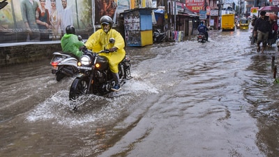 Kochi: Commuters wade through a flooded road amid rains, in Kochi (PTI) Kochi: Commuters wade through a flooded road amid rains, in Kochi (PTI)