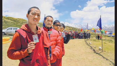 People wait in a queue to cast their votes at the world's highest polling station in Tashigang, Lahaul and Spiti, on Saturday. (PTI)