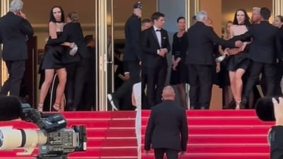 Ukrainian model Sawa Pontyjska and the security guard at the Cannes Film Festival red carpet. Ukrainian model Sawa Pontyjska and the security guard at the Cannes Film Festival red carpet.