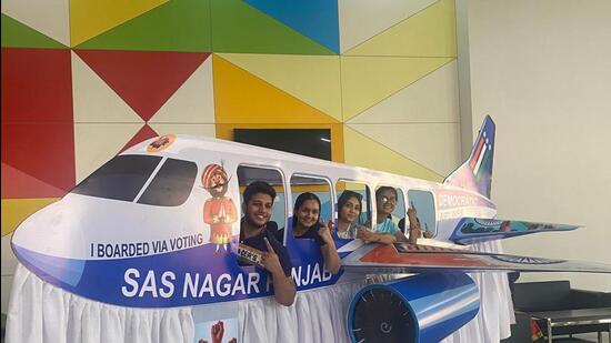 First-time voters are off to a flying start as they flaunt their inked fingers and pose in an aeroplane at a polling booth at Amity International School, Sector 79, Mohali on Saturday. (Sanjeev Sharma/HT)