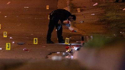 This image, courtesy of News 5 Cleveland, shows an officer of the Akron Police Department investigating a shooting that happened overnight in Akron, Ohio, Sunday (AP) This image, courtesy of News 5 Cleveland, shows an officer of the Akron Police Department investigating a shooting that happened overnight in Akron, Ohio, Sunday (AP)