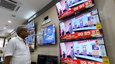 A man watching television waits for the release of exit polls published after voting concluded. (AFP) A man watching television waits for the release of exit polls published after voting concluded. (AFP)