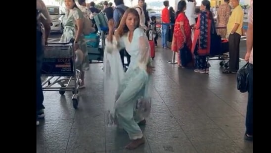 The woman was seen dancing outside an airport.
