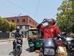 A food delivery executive from Zomato, spotted in Delhi's New Friends Colony, drinks water to keep himself hydrated during the intense heatwave while out on duty. A food delivery executive from Zomato, spotted in Delhi's New Friends Colony, drinks water to keep himself hydrated during the intense heatwave while out on duty.