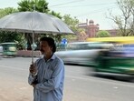 A man takes shelter under an umbrella during severe heatwave on a hot summer day in New Delhi on May 21, 2024. Indian authorities in the capital have ordered schools shut early for the summer holiday, after temperatures hit 47.4 degrees Celsius (117 degrees Fahrenheit) with Delhi gripped by a "severe heatwave". (Photo by Money SHARMA / AFP) A man takes shelter under an umbrella during severe heatwave on a hot summer day in New Delhi on May 21, 2024. Indian authorities in the capital have ordered schools shut early for the summer holiday, after temperatures hit 47.4 degrees Celsius (117 degrees Fahrenheit) with Delhi gripped by a "severe heatwave". (Photo by Money SHARMA / AFP)