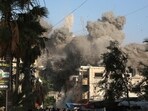 Dust and black smoke rises moments after an Israeli air strike targeted a residential building in the city of Bureij, in the central Gaza Strip on June 3, 2024