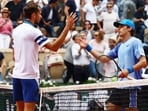 Australia's Alex de Minaur shakes hands with Russia's Daniil Medvedev.