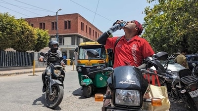 A food delivery executive from Zomato, spotted in Delhi's New Friends Colony, drinks water to keep himself hydrated during the intense heatwave while out on duty. (Photo: Anurag Verma/HT) A food delivery executive from Zomato, spotted in Delhi's New Friends Colony, drinks water to keep himself hydrated during the intense heatwave while out on duty. (Photo: Anurag Verma/HT)