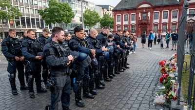 German police officers commemorate a colleague in Mannheim Germany, after learning that a police officer, who was stabbed two days ago there has died on Sunday (AP) German police officers commemorate a colleague in Mannheim Germany, after learning that a police officer, who was stabbed two days ago there has died on Sunday (AP)