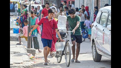 Locals fill water from a Delhi Jal Board water tanker at New Ashok Nagar area in New Delhi on Monday. (HT Photo) Locals fill water from a Delhi Jal Board water tanker at New Ashok Nagar area in New Delhi on Monday. (HT Photo)