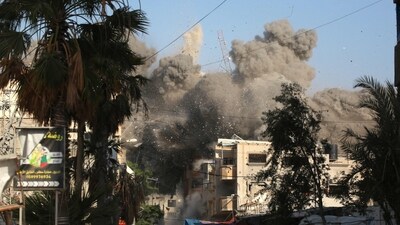 Dust and black smoke rises moments after an Israeli air strike targeted a residential building in the city of Bureij, in the central Gaza Strip on June 3, 2024 (AFP) Dust and black smoke rises moments after an Israeli air strike targeted a residential building in the city of Bureij, in the central Gaza Strip on June 3, 2024 (AFP)