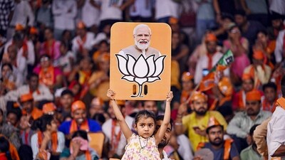 Stock market: A child holds a placard depicting PM Modi and BJP election symbol during a public meeting addressed by Uttar Pradesh Chief Minister Yogi Adityanath for Lok Sabha polls, in Varanasi. (PTI) Stock market: A child holds a placard depicting PM Modi and BJP election symbol during a public meeting addressed by Uttar Pradesh Chief Minister Yogi Adityanath for Lok Sabha polls, in Varanasi. (PTI)