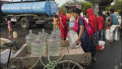 People collect drinking water from a Delhi Jal Board tanker on a hot summer day at a slum in Geeta Colony area of East Delhi on Sunday. (PTI Photo) People collect drinking water from a Delhi Jal Board tanker on a hot summer day at a slum in Geeta Colony area of East Delhi on Sunday. (PTI Photo)