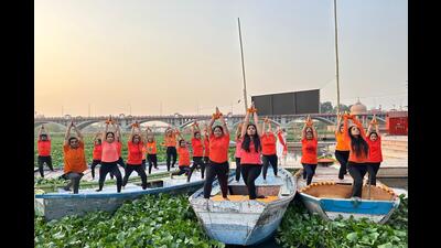 Students practice yoga on boats at Kudia ghat in Lucknow. (HT)