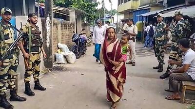 ecurity personnel keep vigil as voters arrive at a polling booth during repolling in West Bengal’s North 24 Parganas on Monday. (PTI) ecurity personnel keep vigil as voters arrive at a polling booth during repolling in West Bengal’s North 24 Parganas on Monday. (PTI)