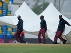 Ground staff cover the pitch as rains stops an ICC Men's T20 World Cup cricket match between England and Scotland' at Kensington Oval Ground staff cover the pitch as rains stops an ICC Men's T20 World Cup cricket match between England and Scotland' at Kensington Oval