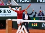 Serbia's Novak Djokovic (L) celebrates after winning against Argentina's Francisco Cerundolo at the end of their men's singles round of sixteen match on Court Philippe-Chatrier on day nine of the French Open tennis tournament
