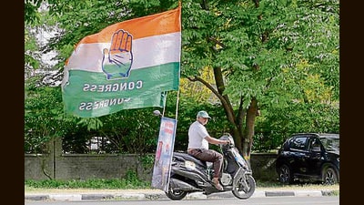A Congress supporter rides a scooter with party’s flag after announcement of results, in Ludhiana. (Gurpreet Singh/HT) A Congress supporter rides a scooter with party’s flag after announcement of results, in Ludhiana. (Gurpreet Singh/HT)