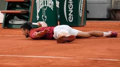 Serbia's Novak Djokovic slid to the net to play a shot during the fourth round match of the French Open tennis tournament against Argentina's Francisco Cerundolo at the Roland Garros stadium in Paris, Monday (AP) Serbia's Novak Djokovic slid to the net to play a shot during the fourth round match of the French Open tennis tournament against Argentina's Francisco Cerundolo at the Roland Garros stadium in Paris, Monday (AP)