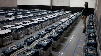 An election staff member stands next to VVPATs and EVMs inside a strongroom in Ahmedabad. (REUTERS)