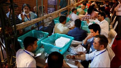 Election officials count postal ballots inside a counting centre in Delhi (REUTERS) Election officials count postal ballots inside a counting centre in Delhi (REUTERS)