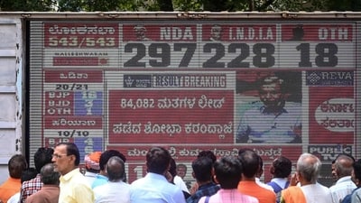 People watch latest election results live on a large screen at the Bharatiya Janata Party (BJP) office in Bengaluru on June 4, 2024. (AFP) People watch latest election results live on a large screen at the Bharatiya Janata Party (BJP) office in Bengaluru on June 4, 2024. (AFP)