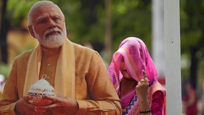 A woman shows her index fingers marked with an indelible ink as she poses for a photograph next to a cutout portrait of Prime Minister Narendra Modi after casting her vote in the seventh and final phase of India's national elections, in Varanasi, (AP) A woman shows her index fingers marked with an indelible ink as she poses for a photograph next to a cutout portrait of Prime Minister Narendra Modi after casting her vote in the seventh and final phase of India's national elections, in Varanasi, (AP)