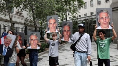 FILE PHOTO: Demonstrators hold signs aloft protesting Jeffrey Epstein, as he awaits arraignment in the Southern District of New York on charges of sex trafficking of minors and conspiracy to commit sex trafficking of minors, in New York, U.S., July 8, 2019. REUTERS/Shannon Stapleton/File Photo (REUTERS)