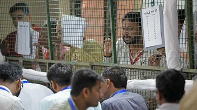 Polling agents at a counting centre in Delhi. (AP) Polling agents at a counting centre in Delhi. (AP)