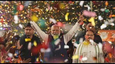 Prime Minister Narendra Modi greets party workers upon his arrival for a meeting at the party headquarters as the party leads in the Lok Sabha elections amid the counting of votes, in New Delhi, on Tuesday. (PTI) Prime Minister Narendra Modi greets party workers upon his arrival for a meeting at the party headquarters as the party leads in the Lok Sabha elections amid the counting of votes, in New Delhi, on Tuesday. (PTI)