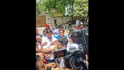 SP workers distributing sweets outside party office in Lucknow (HT Photo)