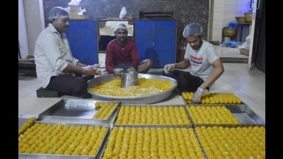 Workers at a sweet shop in Manimajra preparing laddoos for the winning parties ahead of counting of votes on Tuesday. (Sant Arora/HT)