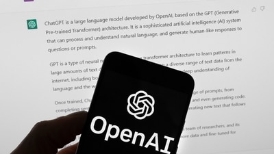 The OpenAI logo is seen on a mobile phone in front of a computer screen which displays output from ChatGPT. (AP) The OpenAI logo is seen on a mobile phone in front of a computer screen which displays output from ChatGPT. (AP)