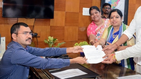 Visakhapatnam, Apr 23 (ANI): YSR Congress Party candidate Botsa Jhansi Lakshmi files her nomination papers from the Vizag constituency for the Lok Sabha Polls, in the presence of Andhra Pradesh Education Minister Botsa Satyanarayana, in Visakhapatnam on Tuesday. (ANI Photo) (ANI)