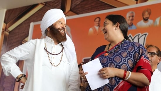BJP’s Faridkot candidate Hans Raj Hans with Union minister Smriti Irani during a poll campaign in Moga on Wednesday.