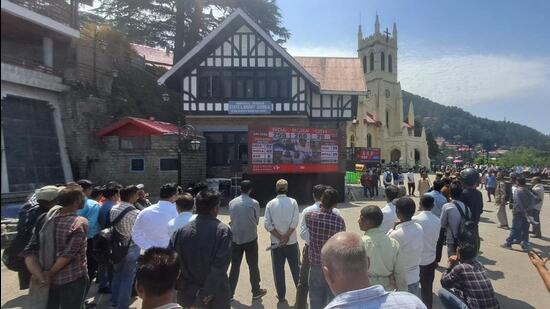 People watching the Lok Sabha election results on a screen installed at the Ridge in Shimla on Tuesday. (Deepak Sansta/HT)