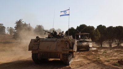 Israeli soldiers gesture while riding in an armoured personnel carrier (APC), after returning from the Gaza Strip, amid the ongoing conflict between Israel and Hamas, near the Israel-Gaza border, in Israel, June 5, 2024. (Reuters)