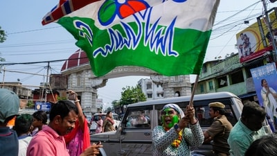 A supporter of Trinamool Congress Party waives a party flag as she celebrates her party's lead in India's national election in Kolkata, India, Tuesday, June 4, 2024. (AP Photo/Bikas Das) (AP)