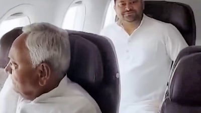 Bihar chief minister Nitish Kumar aboard a flight with RJD leader and former Bihar deputy chief minister Tejashwi Yadav en route to Delhi on Wednesday. (PTI) Bihar chief minister Nitish Kumar aboard a flight with RJD leader and former Bihar deputy chief minister Tejashwi Yadav en route to Delhi on Wednesday. (PTI)