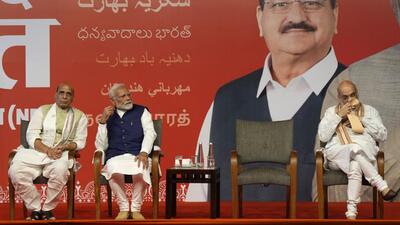 Prime Minister Narendra Modi with defense minister Rajnath Singh and home minister Amit Shah at the Bharatiya Janata Party headquarters in New Delhi on Tuesday. (AP Photo) Prime Minister Narendra Modi with defense minister Rajnath Singh and home minister Amit Shah at the Bharatiya Janata Party headquarters in New Delhi on Tuesday. (AP Photo)