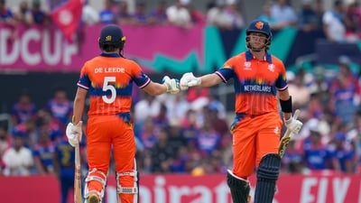 Netherlands' Max O'Dowd, right, bumps gloves with teammate Bas de Leede during their partnership against Nepal at an ICC Men's T20 World Cup cricket match (AP) Netherlands' Max O'Dowd, right, bumps gloves with teammate Bas de Leede during their partnership against Nepal at an ICC Men's T20 World Cup cricket match (AP)