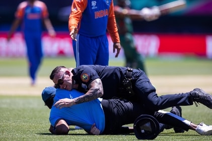 Law enforcement personnel hold down a fan who ran onto the field during an exhibition cricket match between Bangladesh and India at the Nassau County International Cricket Stadium, Saturday, June. 1, 2024, in Westbury, N.Y. The match is a warmup for the T20 Cricket World Cup tournament (AP Photo/Eduardo Munoz Alvarez) (AP) Law enforcement personnel hold down a fan who ran onto the field during an exhibition cricket match between Bangladesh and India at the Nassau County International Cricket Stadium, Saturday, June. 1, 2024, in Westbury, N.Y. The match is a warmup for the T20 Cricket World Cup tournament (AP Photo/Eduardo Munoz Alvarez) (AP)