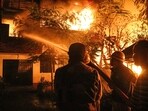An irate mob set fire to abandoned houses belonging to the Kuki community in the nearby area. (PTI) An irate mob set fire to abandoned houses belonging to the Kuki community in the nearby area. (PTI)