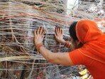 Hindu women tying thread on Banyan tree as part of rituals of Vat Savitri puja.(Mujeeb Faruqui/HT Photo)
