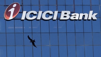 A bird flies past the facade of the ICICI bank head office in Mumbai (REUTERS)