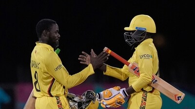 Uganda's Kenneth Waiswa, left, and captain Brian Masaba shake hands to celebrate the team's 3-wicket victory over Papua New Guinea (AP) Uganda's Kenneth Waiswa, left, and captain Brian Masaba shake hands to celebrate the team's 3-wicket victory over Papua New Guinea (AP)