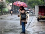 Commuters during light rain in NCR. (File) Commuters during light rain in NCR. (File)